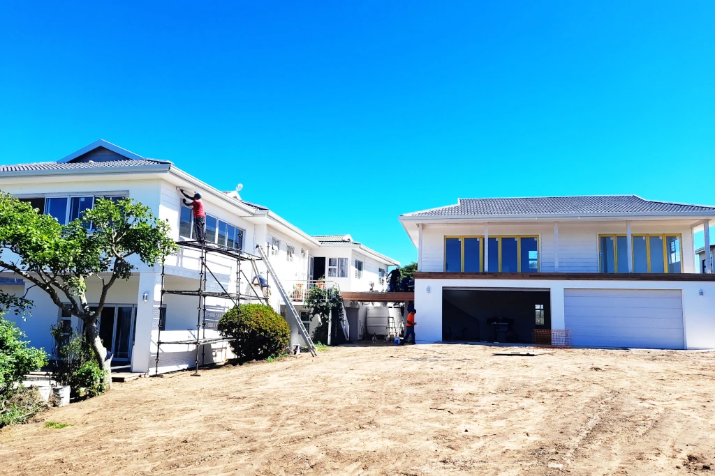 A picture of a building project in progress: an extension to an existing house and a new double storey garage with gym above